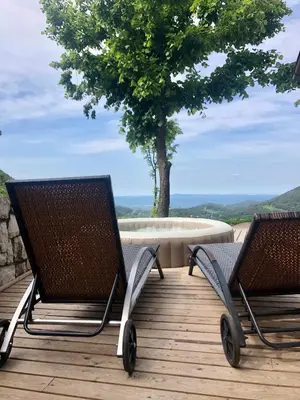 two chairs sitting on a deck with a tree in the background at Kopiše in Zoll