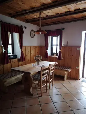 a dining room with a table and chairs and windows at Kopiše in Zoll