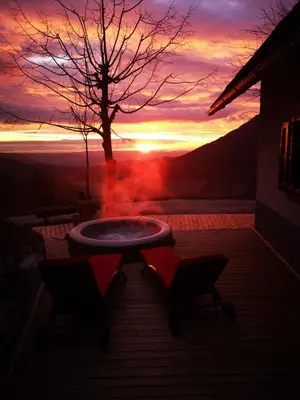 a table and two chairs with a sunset in the background at Kopiše in Zoll
