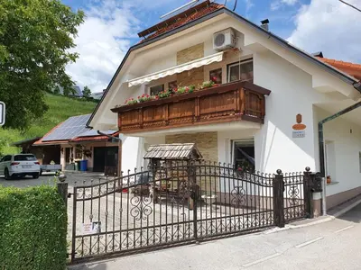 a house with a balcony with flowers on it at APARTMA SVETINA in Bled