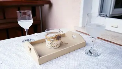 a table with two wine glasses and a box with a spider in it at APARTMA SVETINA in Bled