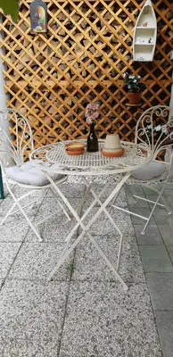 a white table with two chairs and a vase on it at APARTMA SVETINA in Bled