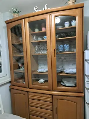 a wooden cabinet with dishes in it in a kitchen at APARTMA SVETINA in Bled