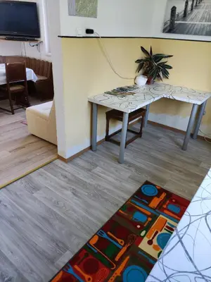 a living room with a table and a rug at Apartma Vita in Rečica ob Savinji