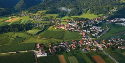 an aerial view of a village in a green field at Apartma Vita in Rečica ob Savinji