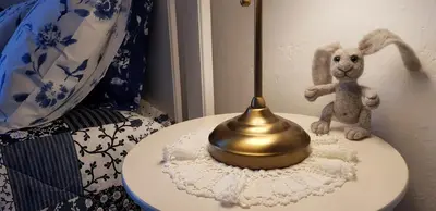 a gold bell sitting on a table with a stuffed rabbit at SavaDolinka House ID 116O7O in Mojstrana