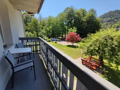 a balcony with chairs and a view of a park at Lake House Sebanc in Bled
