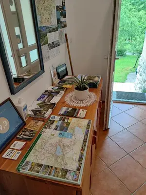 a table with maps and photographs on it at Lake House Sebanc in Bled