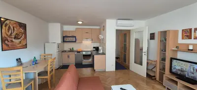 a living room with a kitchen and a dining room at Apartment Irena Tour As Ljubljana in Ljubljana