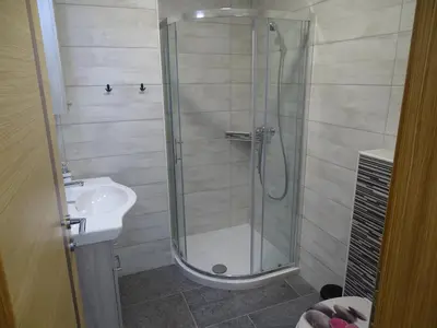 a bathroom with a shower and a sink at Apartments Laura FARM STAY in Podčetrtek