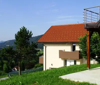 a white building with a red roof at Apartments Laura FARM STAY in Podčetrtek