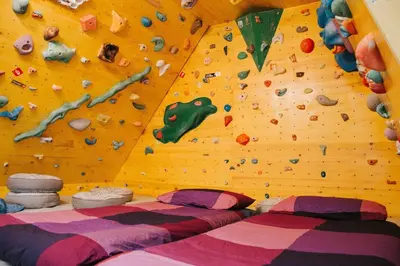 a bedroom with a climbing wall and two beds at Apartment Kapitan with climbing wall in Kobarid
