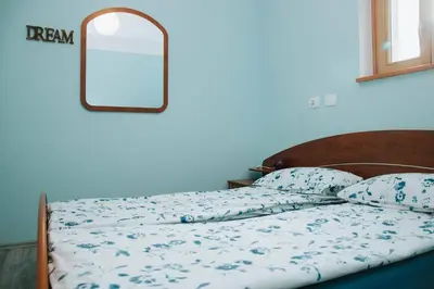 a bedroom with a bed with a mirror on the wall at Apartment Kapitan with climbing wall in Kobarid