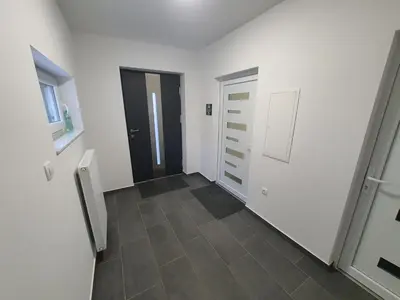 a hallway with two doors and a tile floor at Apartment Šelih in Maribor
