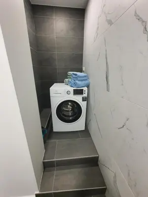 a staircase with a washing machine in a bathroom at Apartment Šelih in Maribor