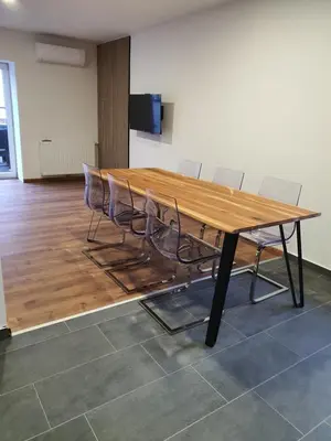 a large wooden table with chairs in a room at Apartment Šelih in Maribor