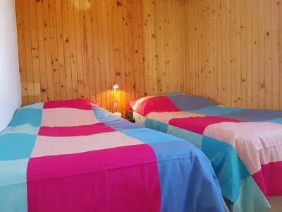 two beds with colorful sheets in a room at Apartma Unica in Bled