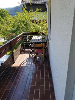 a patio with a table and chairs on a balcony at Apartma Unica in Bled