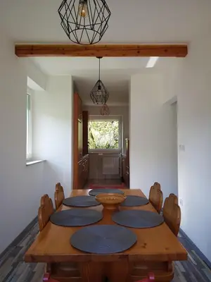 a dining room with a wooden table and chairs at Apartma Unica in Bled