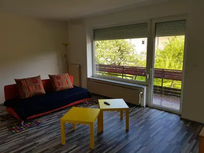 a living room with a couch and a table and a window at Apartma Unica in Bled