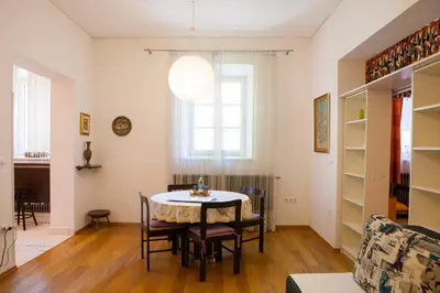 a dining room with a table and chairs at Rimska Apartments Tour As Ljubljana in Ljubljana