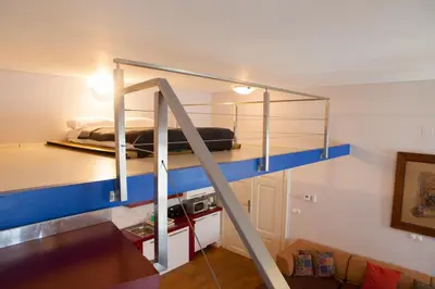 a bunk bed in a room with a ladder at Rimska Apartments Tour As Ljubljana in Ljubljana