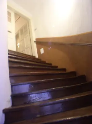 a set of stairs in a building with a door at Rimska Apartments Tour As Ljubljana in Ljubljana