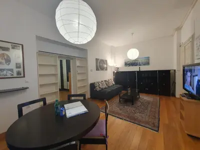 a living room with a table and a couch at Rimska Apartments Tour As Ljubljana in Ljubljana