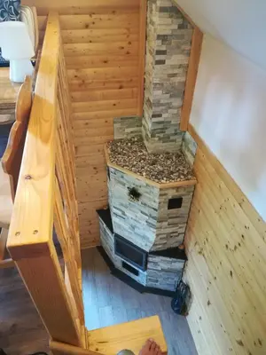 a tiny house with a fireplace in the floor at Brunarica Lorentia in Bizeljsko