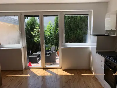 an empty kitchen with a sliding glass door at Villa Acernis in Postojna