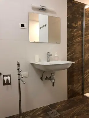 a bathroom with a sink and a mirror on the wall at Villa Acernis in Postojna