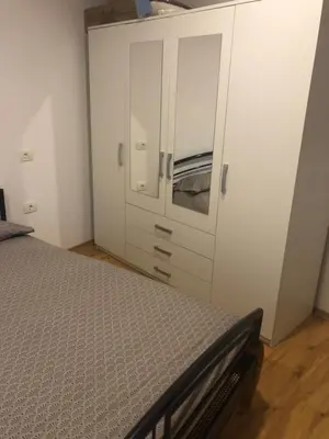 a bedroom with a bed and a white cabinet at Villa Acernis in Postojna