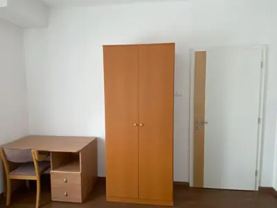 a wooden cabinet next to a desk and a door at Villa Acernis in Postojna