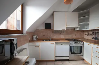 a kitchen with white cabinets and a sink at Spacious 2-bedroom apartment Zabjak with AC Tour As Ljubljana in Ljubljana