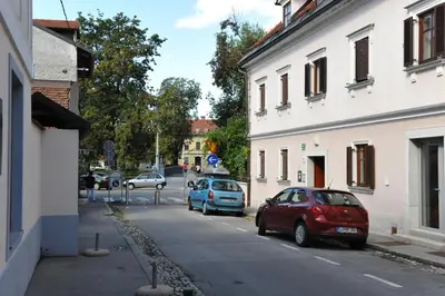 a group of cars parked on the side of a street at Spacious 2-bedroom apartment Zabjak with AC Tour As Ljubljana in Ljubljana