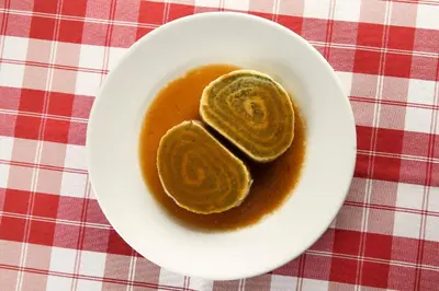 a white bowl of sauce on a table at Guesthouse Muha in Lipica