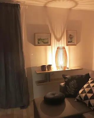 a living room with a couch and a lamp at Lesnavesna designer Apartment with a garden in Visoko