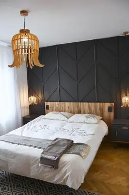 a bedroom with a large bed with a black headboard at Lesnavesna designer Apartment with a garden in Visoko