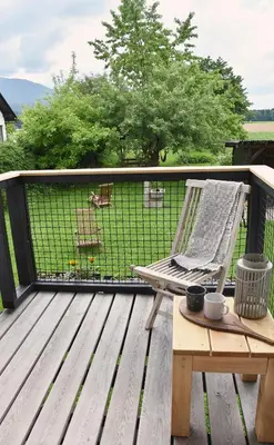 a wooden deck with a chair and a table at Lesnavesna designer Apartment with a garden in Visoko