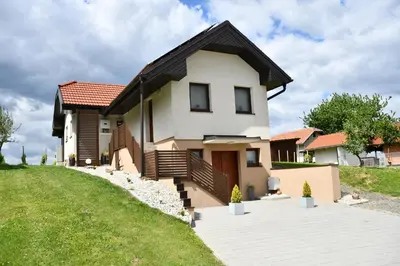 a white house with a black roof at Zidanica Lan in Lendava