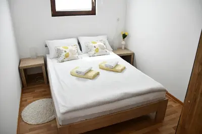 a bedroom with a bed with two towels on it at Zidanica Lan in Lendava