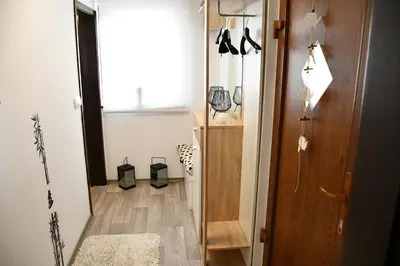 a room with a hallway with a door and a floor at Zidanica Lan in Lendava