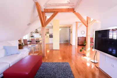 a living room with a white couch and a flat screen tv at Apartment in the heart of Bled with views in Bled