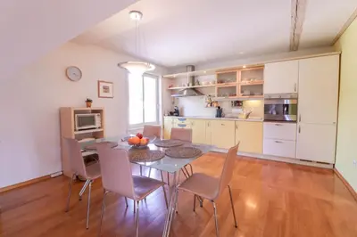 a kitchen and dining room with a table and chairs at Apartment in the heart of Bled with views in Bled