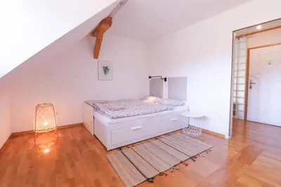 a bedroom with a bed in the corner of a room at Apartment in the heart of Bled with views in Bled