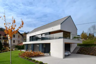 a white house with a black roof at Studio ELITE in Bled