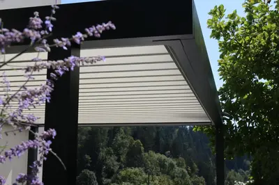 a window with a roller blind in a house with purple flowers at Studio ELITE in Bled