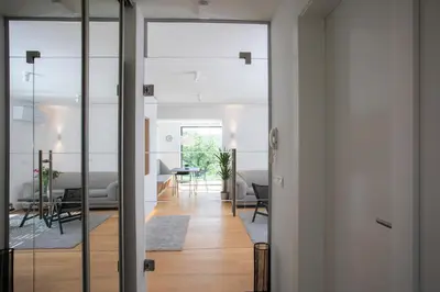 a hallway with glass doors leading into a living room at Studio ELITE in Bled