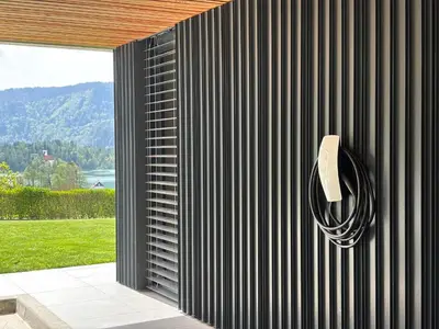 a black wall with a hose attached to a building at Studio ELITE in Bled