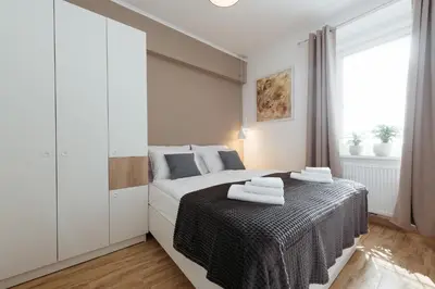 a bedroom with a bed with towels on it at Apartments Tivoli in Ljubljana